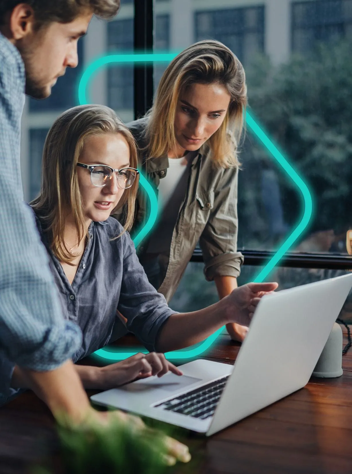 team huddled around laptop